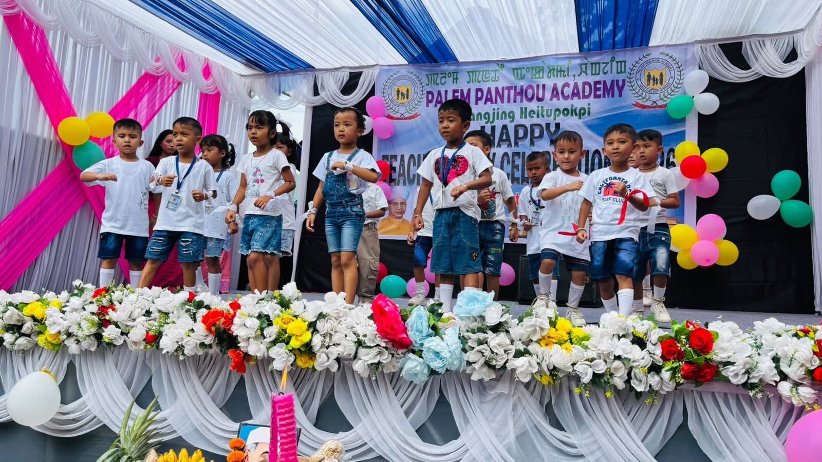Children in costume presenting a cultural item on stage