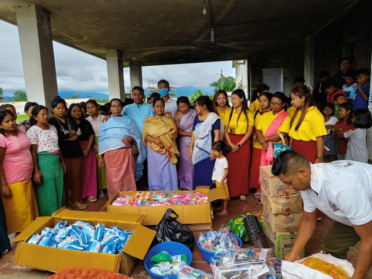 Community members collecting food and hygiene supplies from relief crates