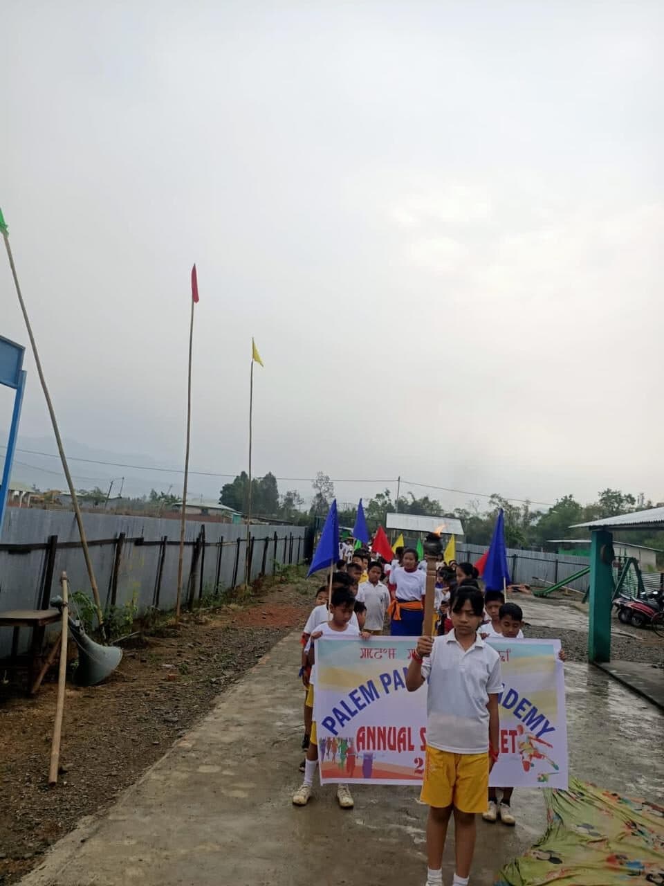 The annual sports meet procession behind the foundation banner